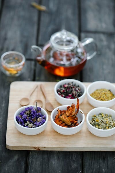 Teapot and bowls of dried herbs.