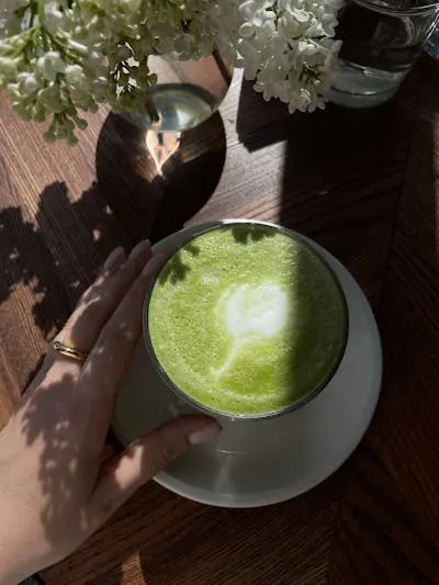 Green tea latte with a leaf design.