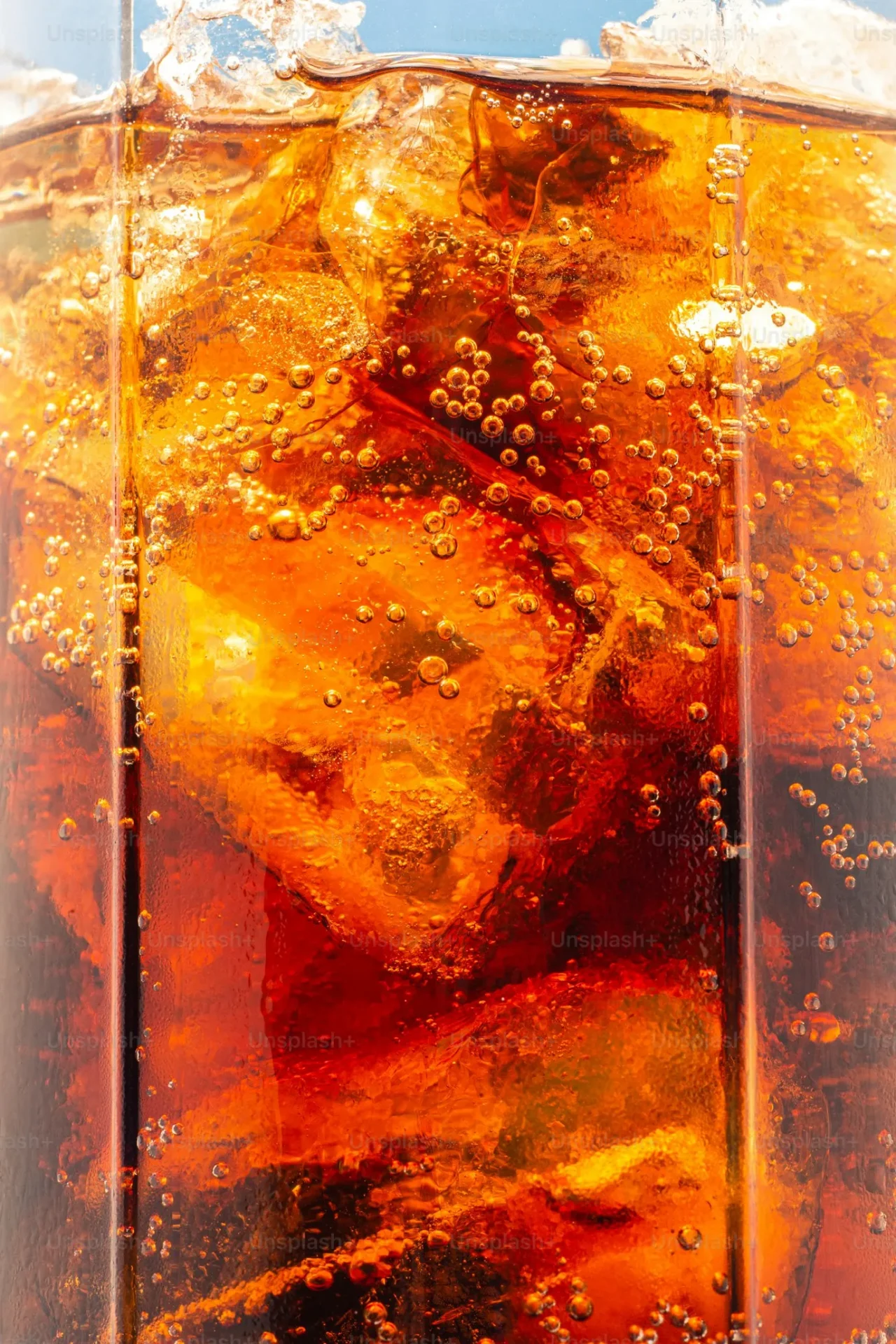 Close-up of cola with ice cubes.