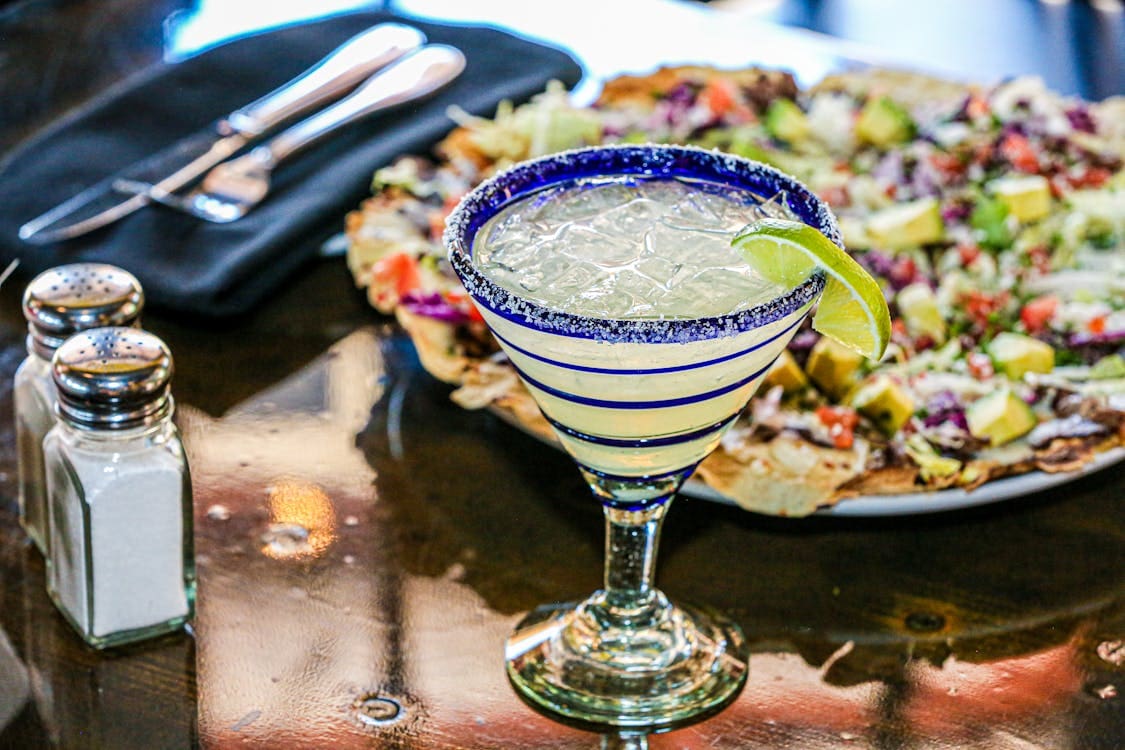 Margarita with lime wedge and salt rim.