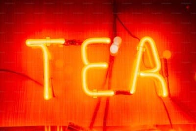 Neon sign spelling out the word "TEA"